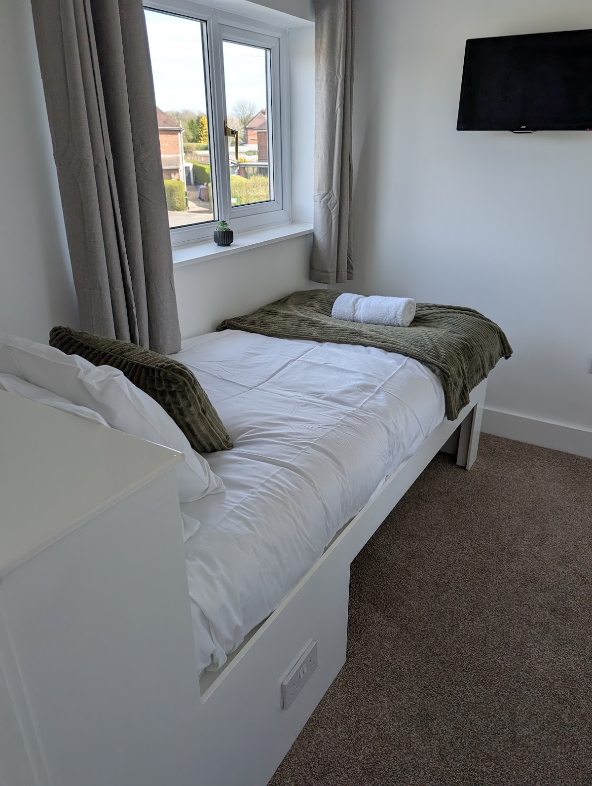 A freshly made single bedroom